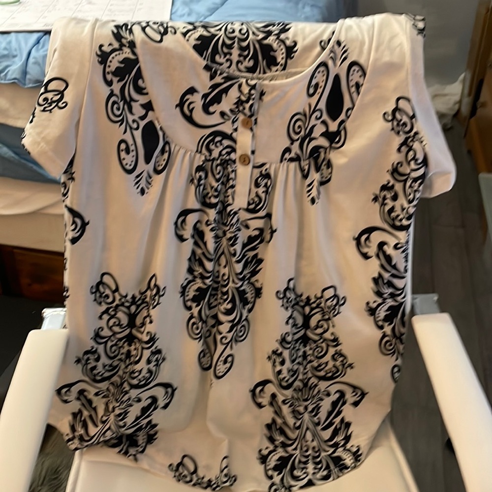 Women’s top, black and white, three buttons in the front. Like new!